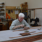 Color photo of Jim Jackson working in his leather workshop