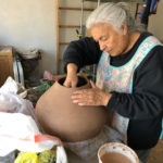 Color photograph of Jody Folwell working on a pot