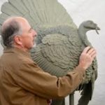 Photograph of Gerald Shippen with a turkey sculpture