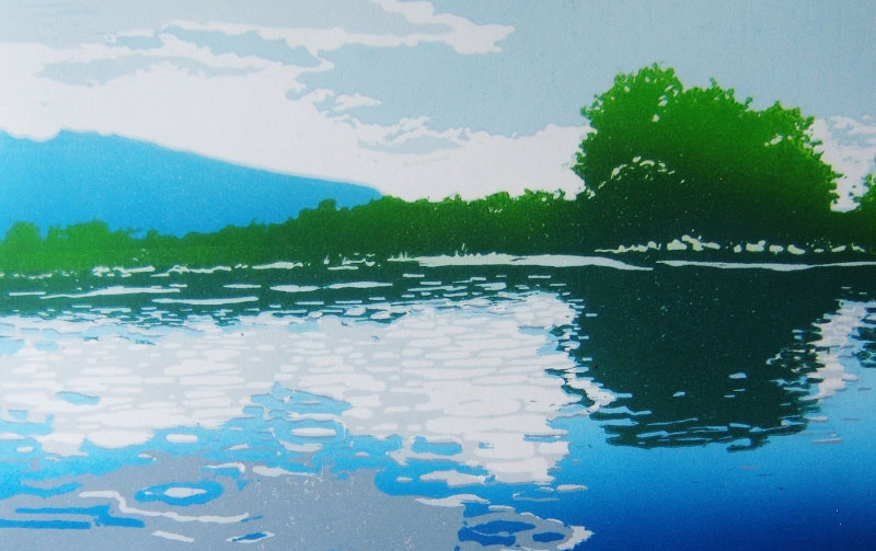 Green, blue and white releif print of a pond with shrubs on the shoreline reflected on the water and a silhouette of a mountain in the back left