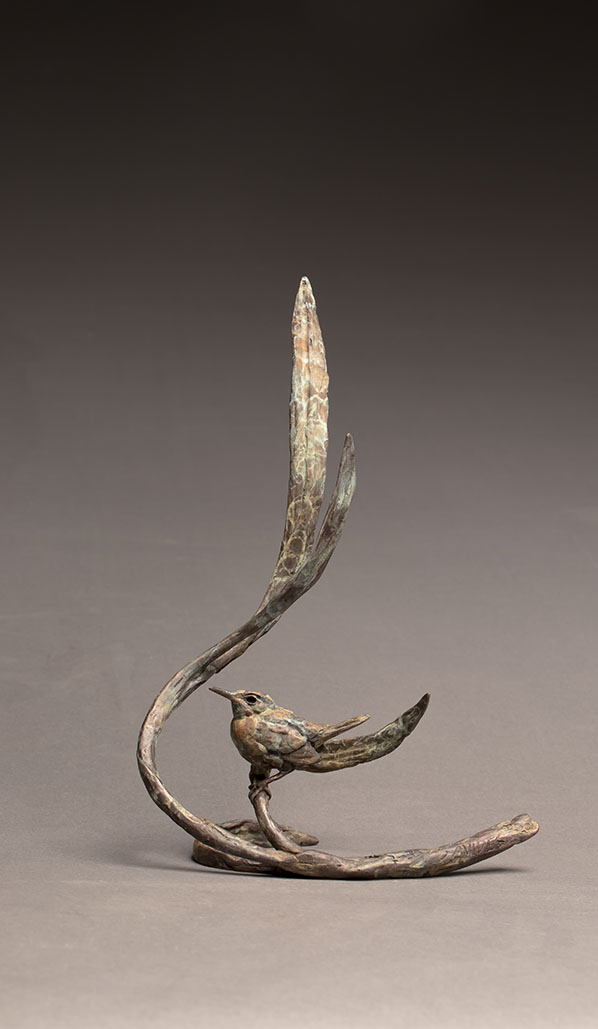 Bronze sculpture of a wren on a branch
